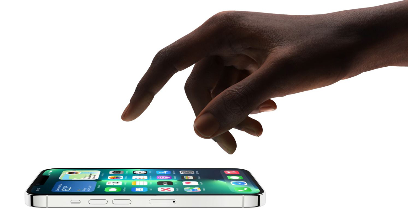 A hand is tapping on an iPhone 13 Pro